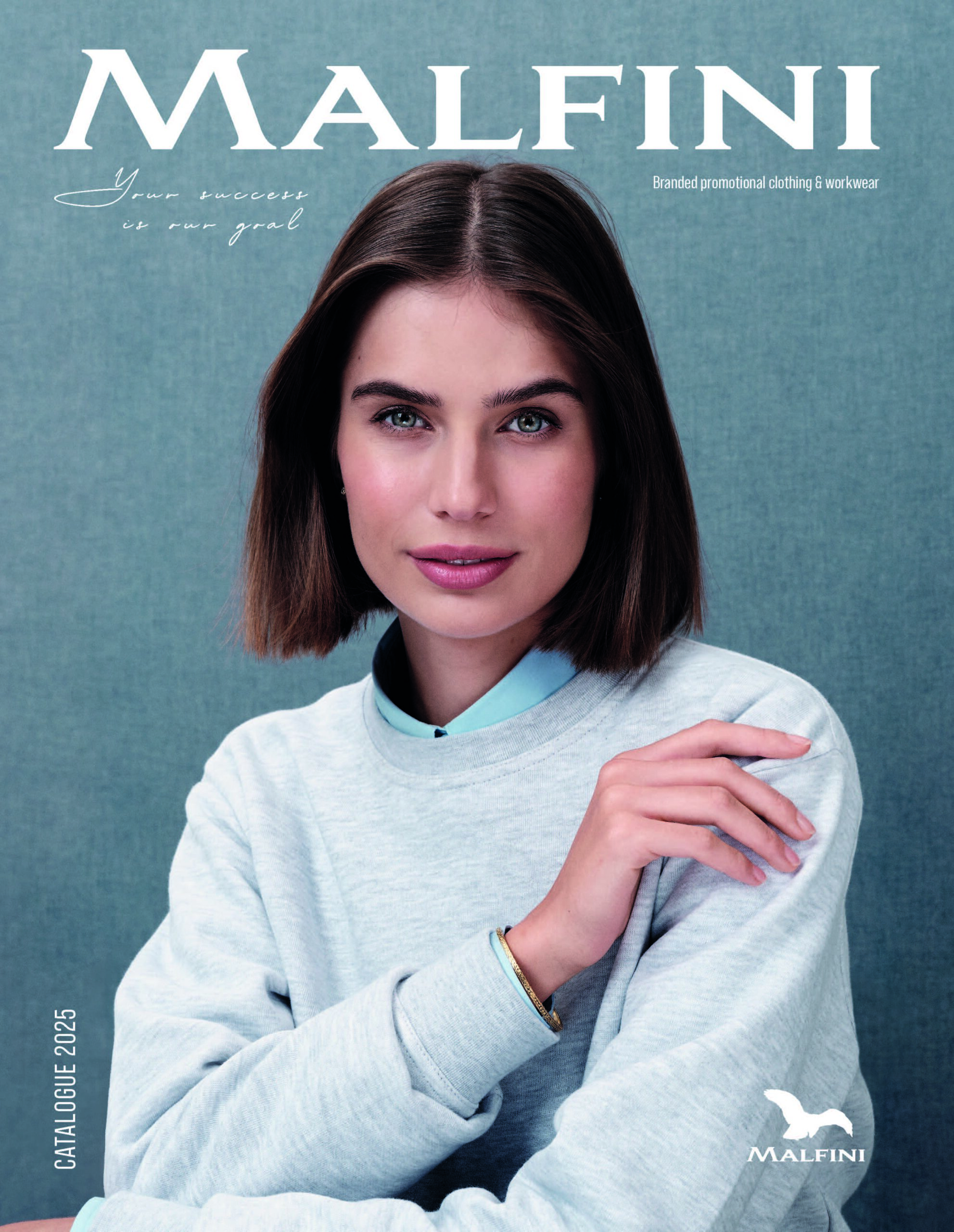 a woman with short brown hair wearing a grey sweater